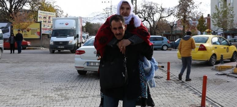 Vefalı evlat 17 yıldır annesini sırtında taşıyor